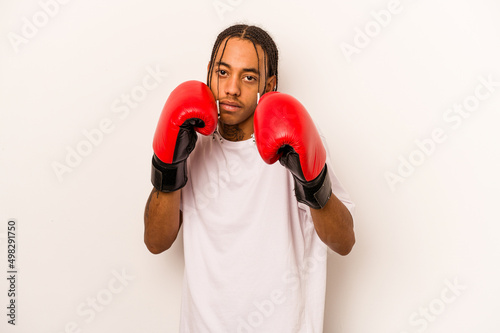 Young African American man playing boxeo isolated on white background © Asier