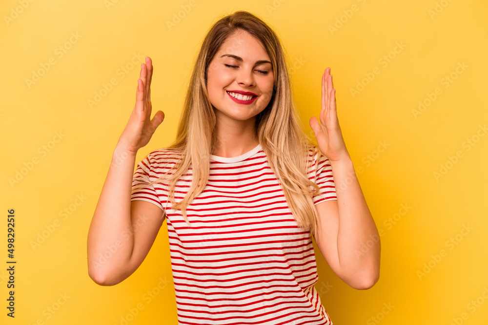 Young caucasian woman isolated on yellow background joyful laughing a lot. Happiness concept. Young caucasian woman isolated on yellow background joyful laughing a lot. Happiness concept.