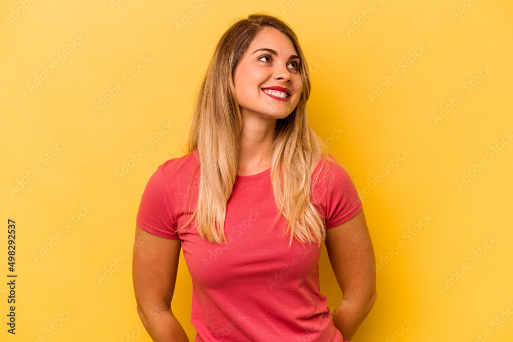 Young caucasian woman isolated on yellow background relaxed and happy laughing, neck stretched showing teeth. Young caucasian woman isolated on yellow background relaxed and happy laughing, neck stretched showing teeth.