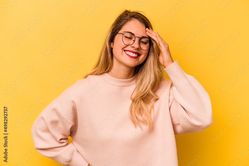 Young caucasian woman isolated on yellow background joyful laughing a lot. Happiness concept.