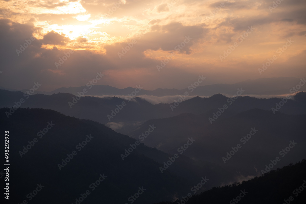 mountain ranges view, valley in the clouds at sunset time