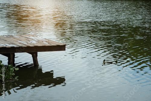 landscape of wooden pier on rural river,