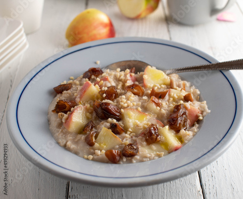 Breakfast porridge with dates, apples and nuts