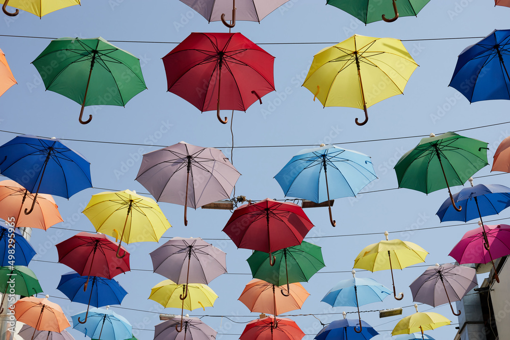 Street decoration of colorful umbrellas. Colorful umbrellas in the sky.