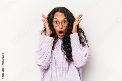 Young hispanic woman isolated on white background surprised and shocked.