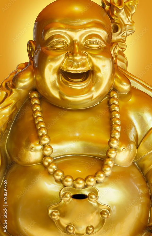 Obraz premium The Golden smiling Buddha or Hotei is the chinese god of happiness, wealth and good luck