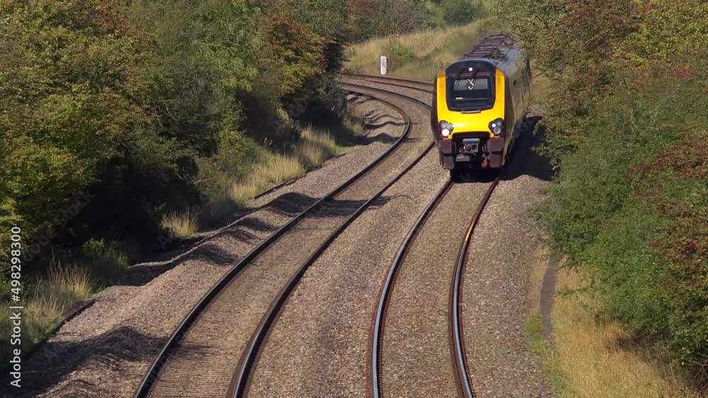 Cross country rail service travelling underneath the camera.
