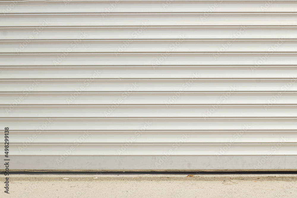 Closed and blank aluminum shutter of the building,background Closed and blank aluminum shutter of the building,background