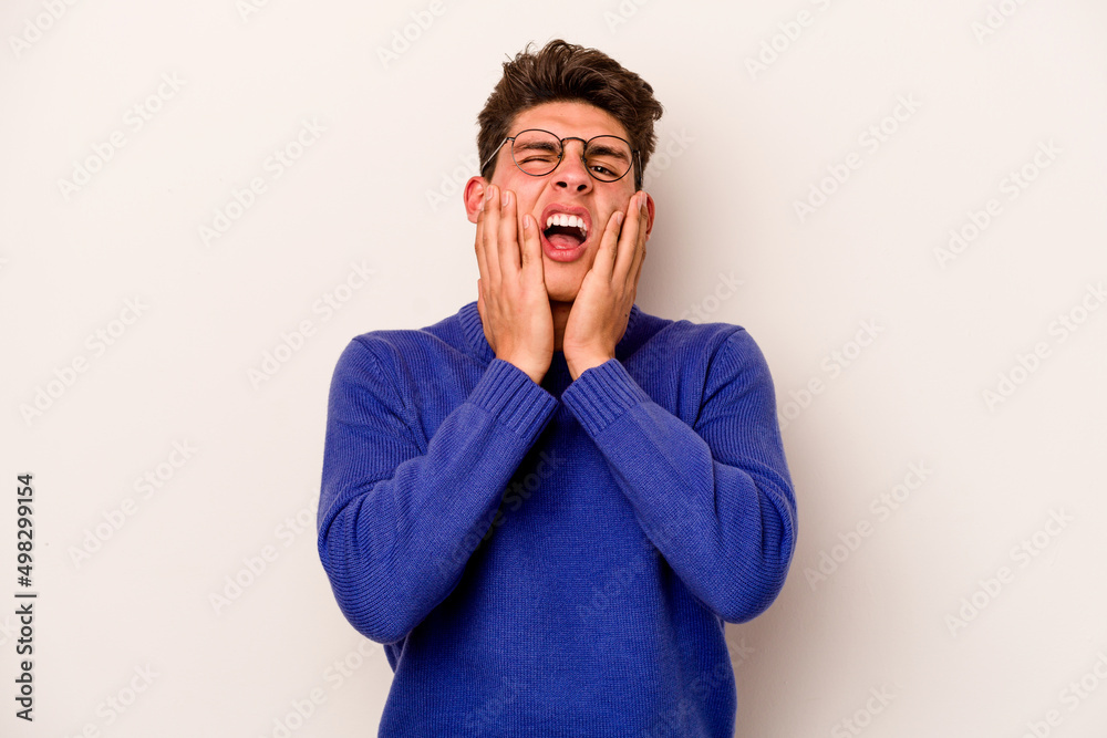 Young caucasian man isolated on white background whining and crying disconsolately.