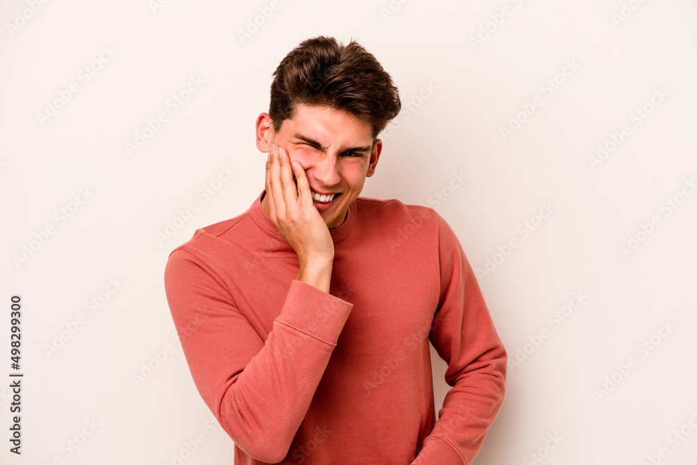 Young caucasian man isolated on white background laughs happily and has fun keeping hands on stomach. Young caucasian man isolated on white background laughs happily and has fun keeping hands on stomach.