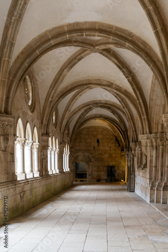 hallway and cloister with elaborate stonemasonry in the Alcobaca Monastery © makasana photo