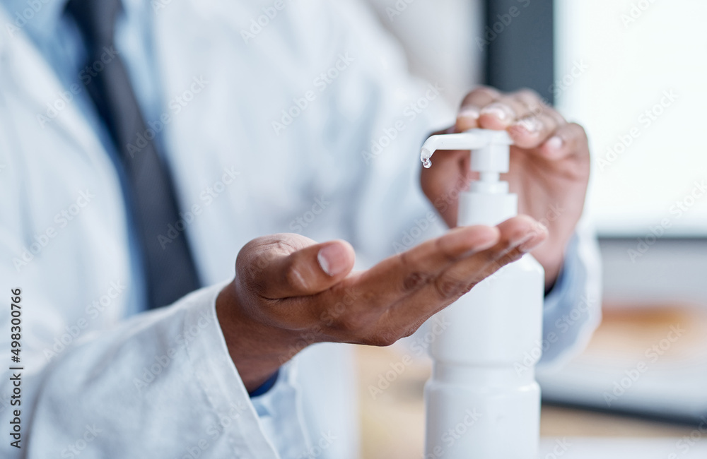 Killing bacteria on the regular. Closeup shot of an unrecognisable doctor using hand sanitiser in a hospital.