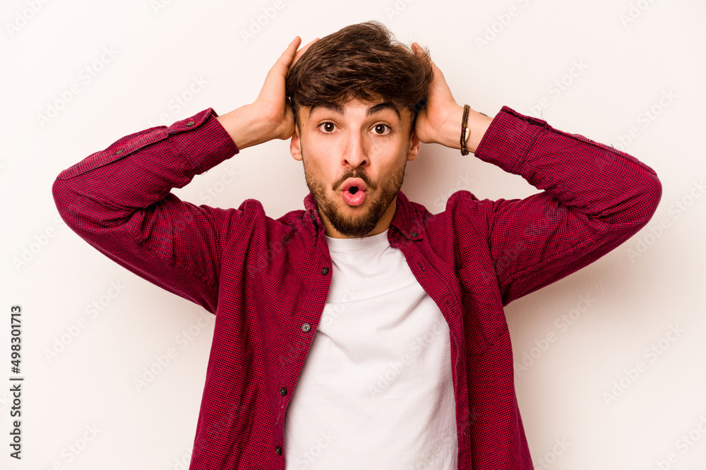Young hispanic man isolated on white background being shocked, she has remembered important meeting. Young hispanic man isolated on white background being shocked, she has remembered important meeting.