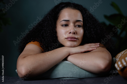 Maybe it wasnt meant to be. Shot of a young woman feeling unhappy at home. photo