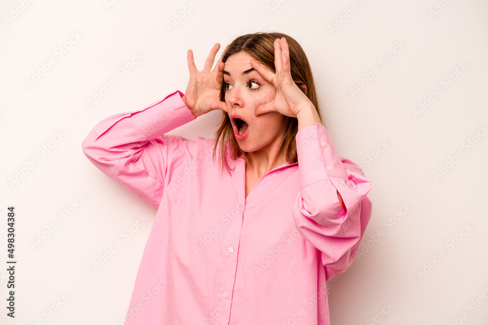 Young caucasian woman isolated on white background keeping eyes opened to find a success opportunity. Young caucasian woman isolated on white background keeping eyes opened to find a success opportunity.