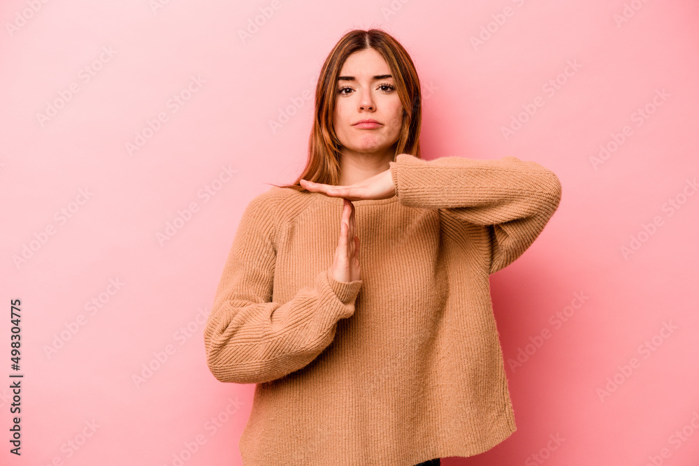 Young caucasian woman isolated on pink background showing a timeout gesture. Young caucasian woman isolated on pink background showing a timeout gesture.