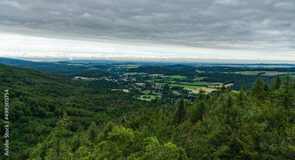 view from hill in valley with small town in forests view from hill in valley with small town in forests