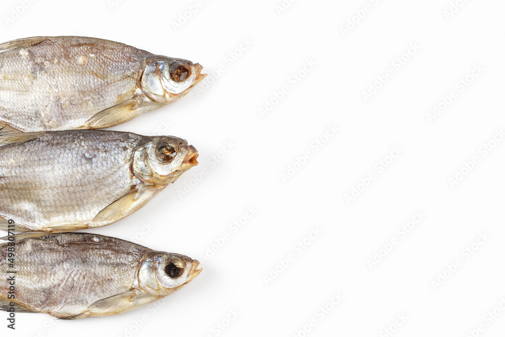 Dried fish isolated on white background. Salty dry river fish. Copy space for a text
