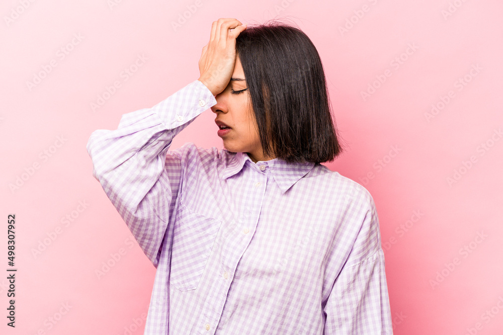 Young hispanic woman isolated on pink background forgetting something, slapping forehead with palm and closing eyes. Young hispanic woman isolated on pink background forgetting something, slapping forehead with palm and closing eyes.