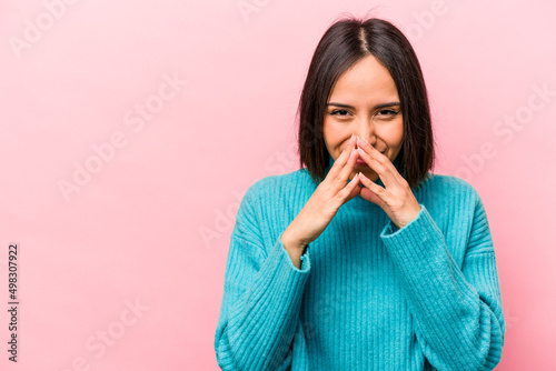 Young hispanic woman isolated on pink background making up plan in mind, setting up an idea.