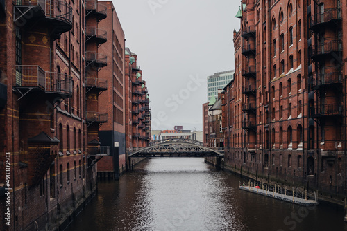 Warehouse district of Hamburg, bridge among architecture, cityscape. © puhimec