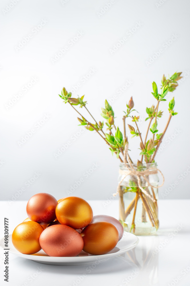 Gold and bronze Easter eggs on white background. Christian holiday symbol. Gold and bronze Easter eggs on white background. Christian holiday symbol.