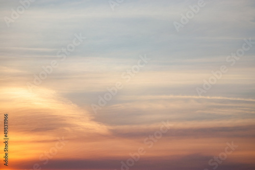 Sunset in sky. Orange and pink striped clouds at twilight. Natural background.