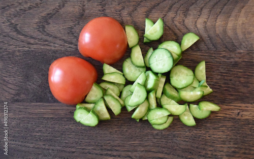 tomatos and cucumbers on the wooden choping board