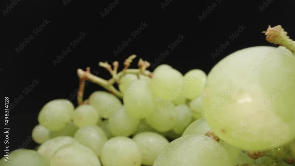 Green grapes on a black background. Dolly slider, rotation. Macro video. Laowa Probe Green grapes on a black background. Dolly slider, rotation. Macro video. Laowa Probe