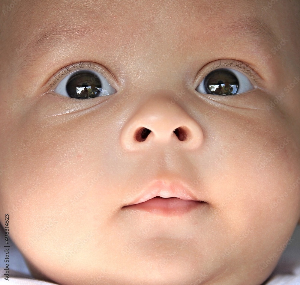baby looking with big eyes just after having a good sleep in bed stock photo baby looking with big eyes just after having a good sleep in bed stock photo