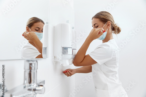 Surgeon washing hands before operating in hospital. Health care and hygiene concept