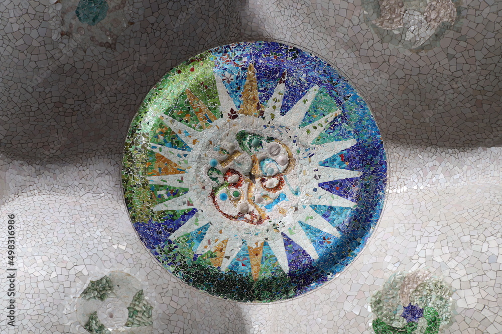 Naklejka premium mosaic in the park guell, Broken multicolored glass background texture, ceramic tile in park Guell, Barcelona, Spain
