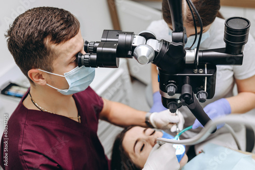 The doctor is using equipment to help the patient.