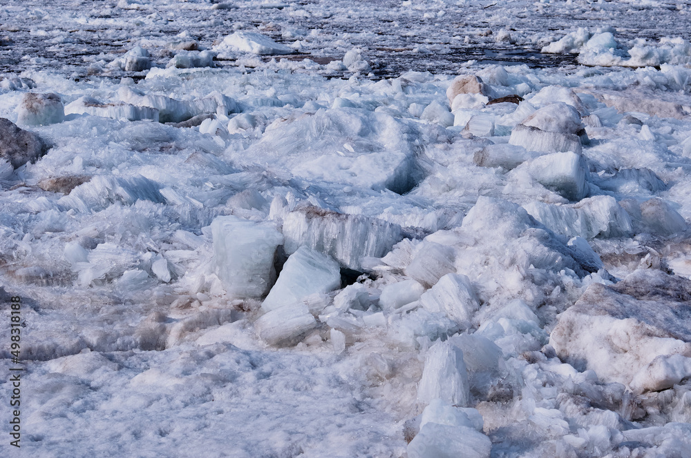 Melting river ice. Columnar and needle-like structure of crystals. Ice floe in the spring on the banks of the Amur River. Melting river ice. Columnar and needle-like structure of crystals. Ice floe in the spring on the banks of the Amur River.