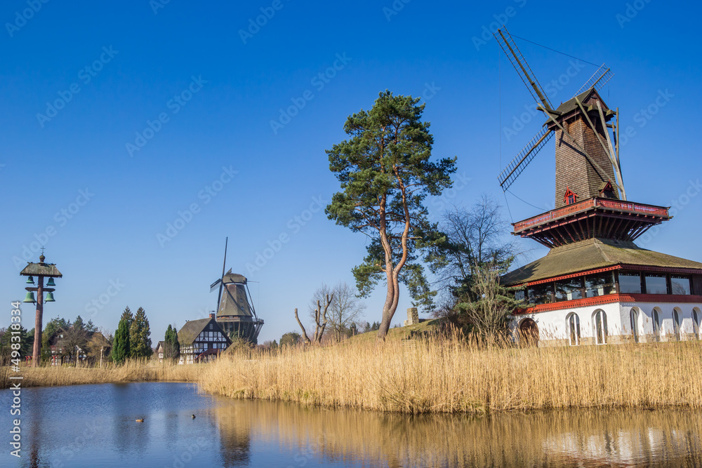 Fototapeta premium Historic windmills and half-timbered house at the lake in Gifhorn, Germany