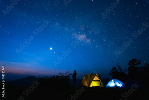milky way with meteor star and hiking tent in summer time