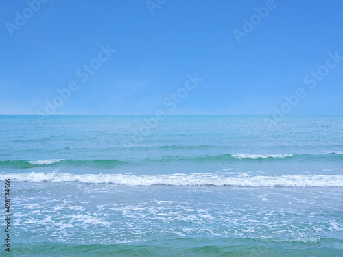The sea with slight waves against the sky background
