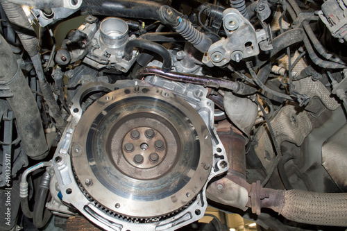 View of a two-mass (damper) flywheel in the engine compartment of a car with the gearbox removed