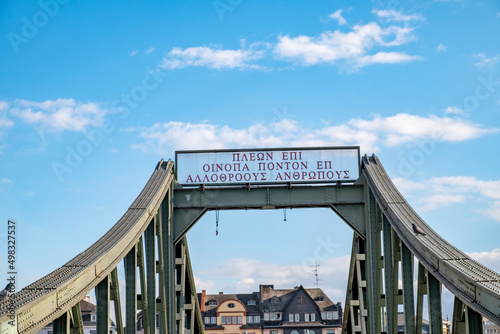 view to footbridge Eiserner Steg in Frankfurt, Germany. The greek inscription at top means engl: I cross the ocean to see other nationalities. It is a sentence from Homers Odyssee. photo