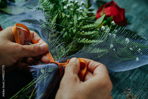 man arranges a red rose for Saint George Day photo