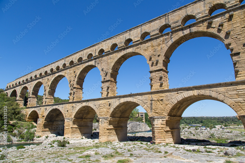 Famous Pont du Gard - an iconic Ancient Roman bridge, aqueduct and engineering masterpiece in the region Provence, France. It is formed by three floors of arcades, massive arches and pillars