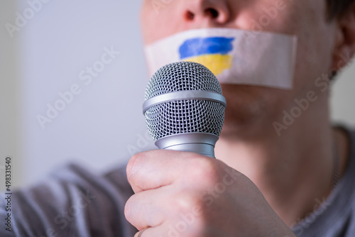 Caucasian man with duct tape on mouth, white . Conceptual image.