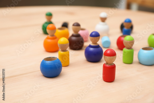 Photo wooden colorful dolls shaped building blocks on table, closeup