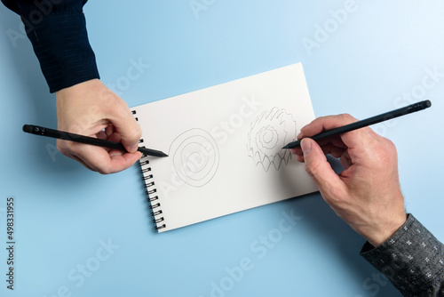 A man and a woman in a notebook perform a parkinson's disease test and hand tremor diagnosis.