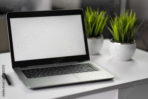 Laptop with white screen ready for business logo or advertising text. Mockup image blank screen with white background. Ideally for shop marketing and creative design. 