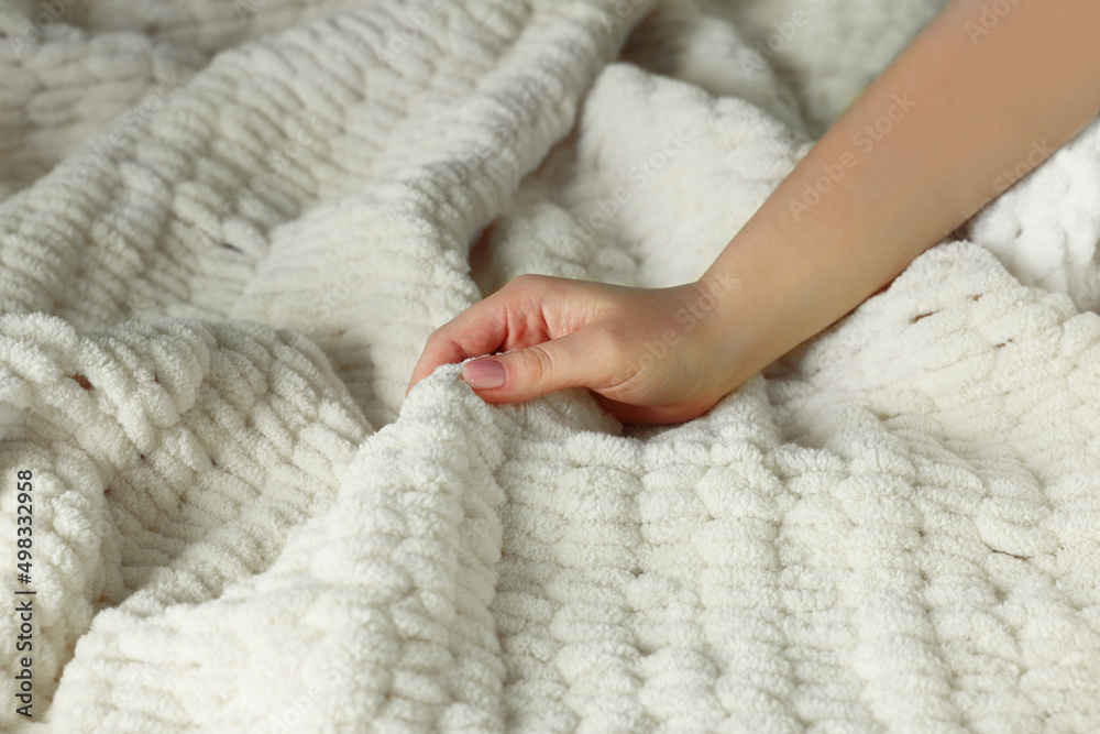 Woman touching soft yellow fabric, closeup view Woman touching soft yellow fabric, closeup view