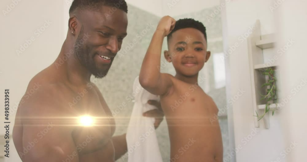 Animation of lights over happy african american father and son taking selfie in bathroom Animation of lights over happy african american father and son taking selfie in bathroom