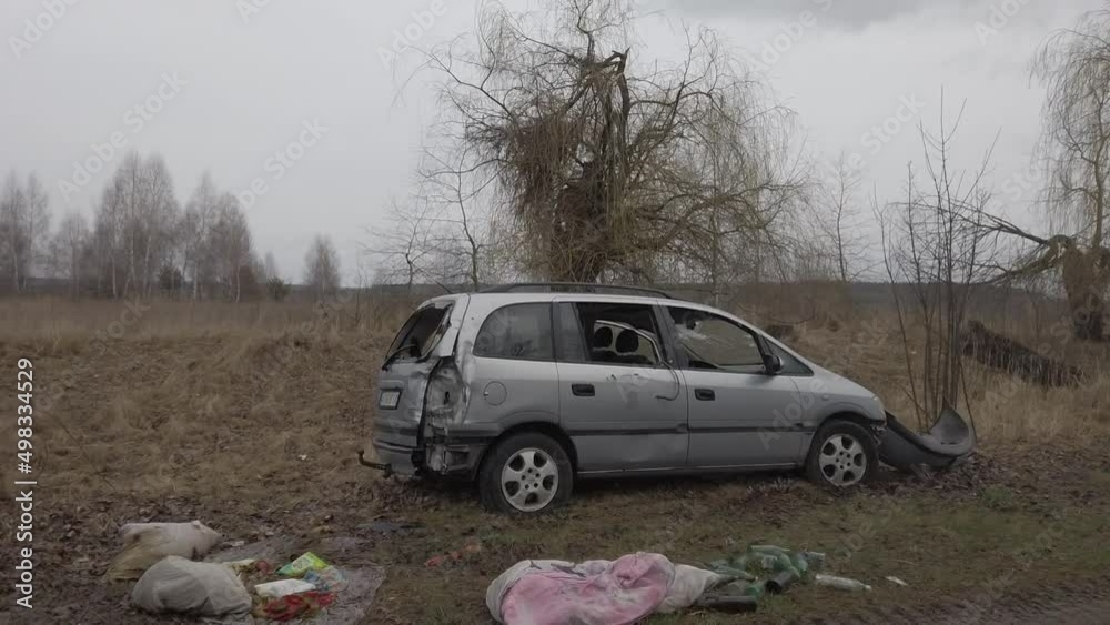 Motyzhin, Kyiv region, Ukraine - April 2022: War between Russia and Ukraine. The consequences of the war, the cars of civilians shot by the Russian army. Explosion-damaged car. Motyzhin, Kyiv region, Ukraine - April 2022: War between Russia and Ukraine. The consequences of the war, the cars of civilians shot by the Russian army. Explosion-damaged car.