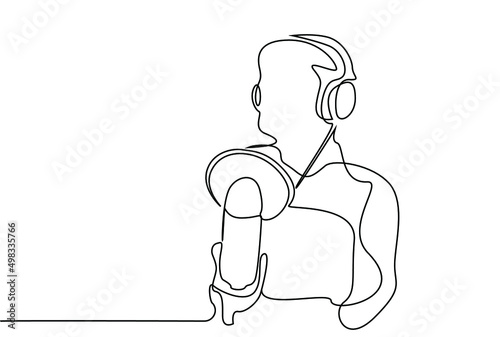 a person with headphones speaks into a microphone. one person takes podcasts and audio recordings