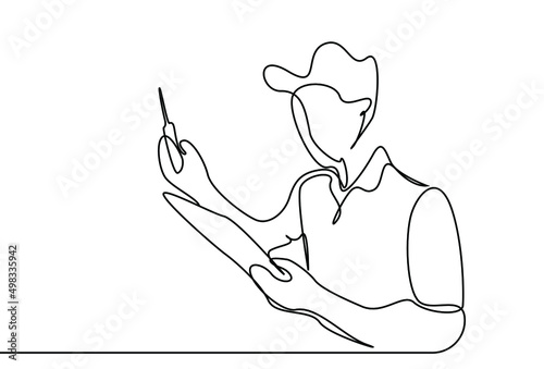 A mechanic holding a tablet in one hand is checking it.